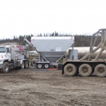 Jim River on Dalton Hwy - Setup for batching with Mobile Mixer, cement silo, water tank, and cement bulker.