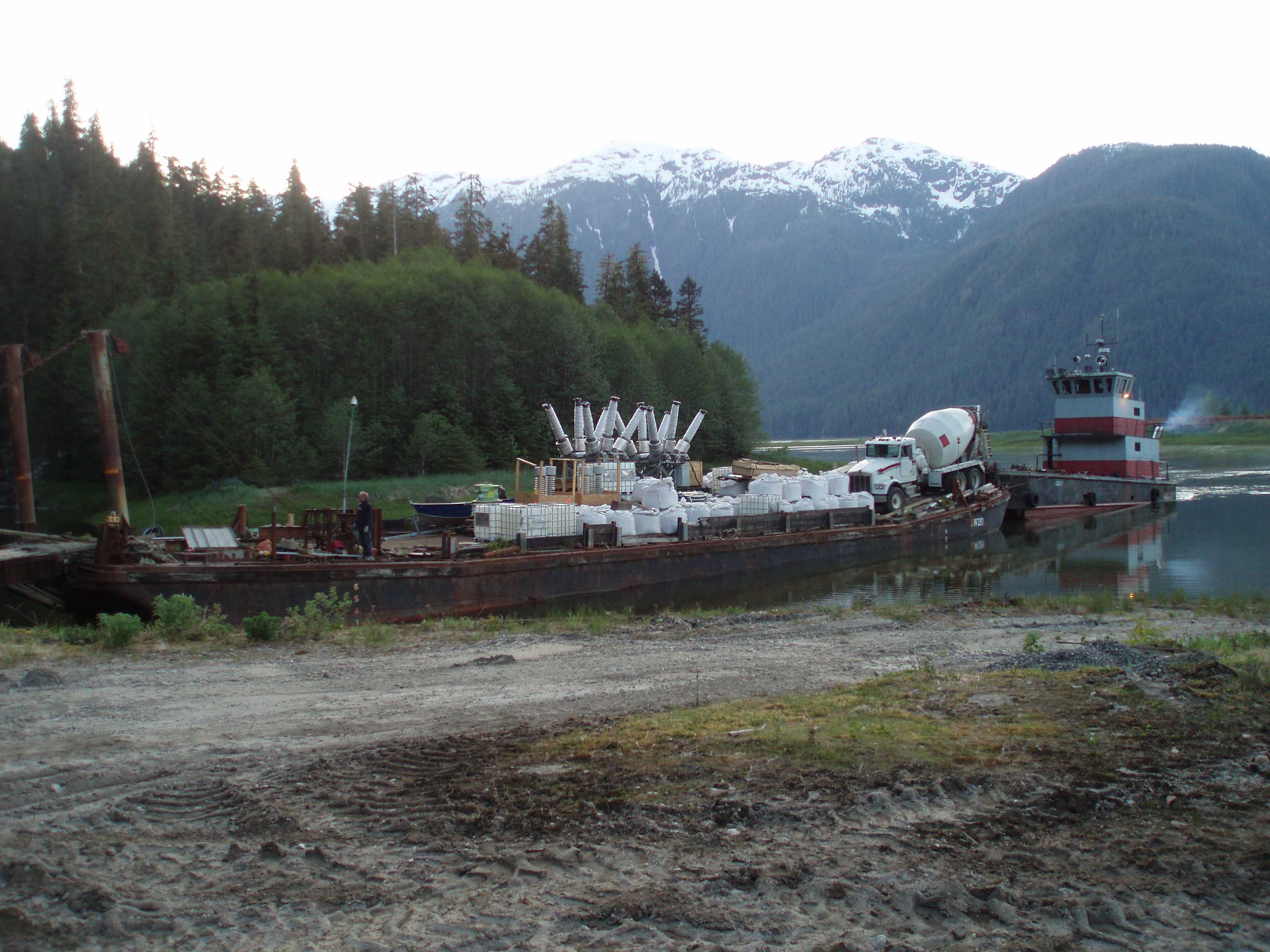 Tyee Lk-Truck, pump, and super bags of concrete materials arriving by barge to the end of Bradfield Canal near Wrangell.